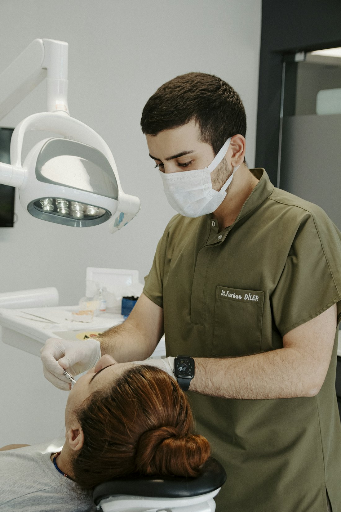 A patient discussing implant payment options with a dental clinic
