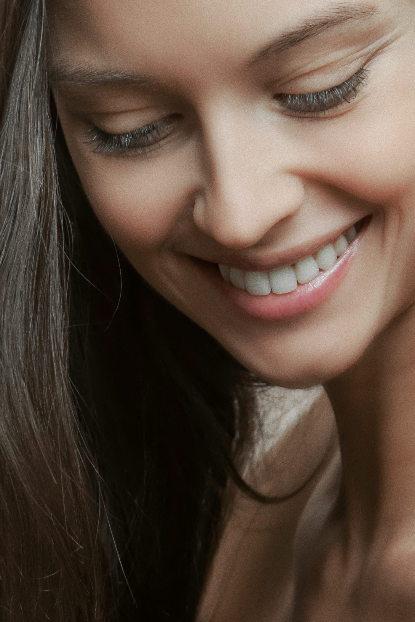 Close-up of a person with a natural, confident smile after dental implants