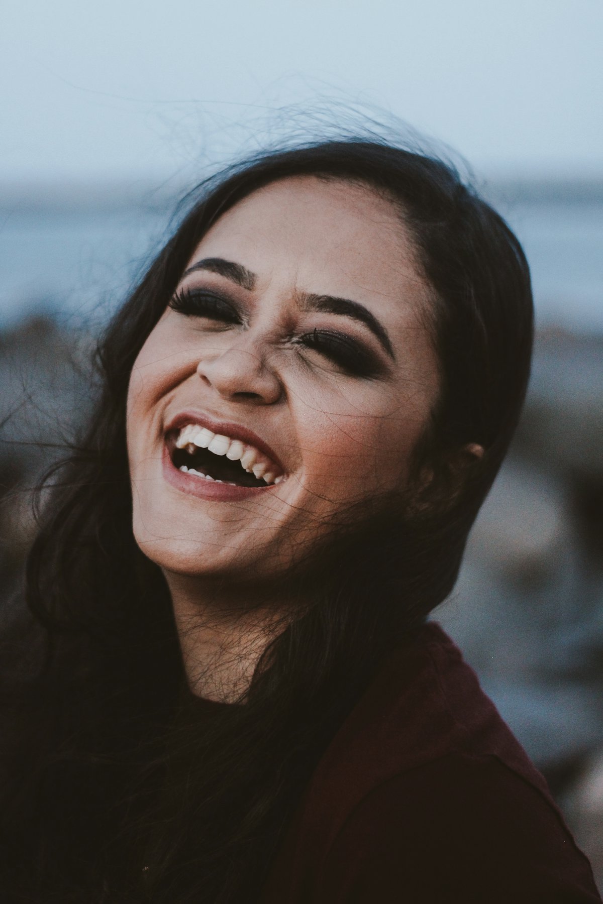 An older adult laughing confidently after restorative dental treatment